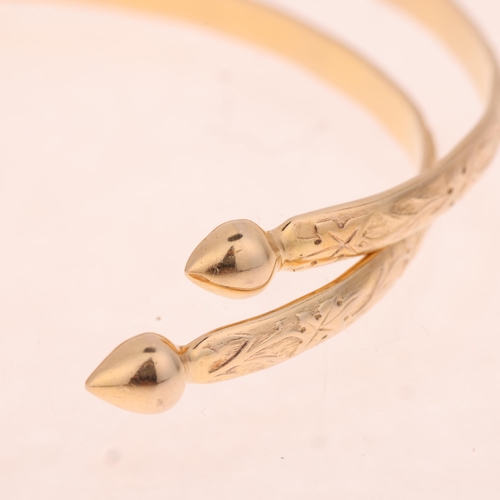 1336 - A pair of 10k gold cuff bangles, relief floral decoration with teardrop terminals, band width 4.3mm,... 