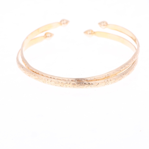 1336 - A pair of 10k gold cuff bangles, relief floral decoration with teardrop terminals, band width 4.3mm,... 