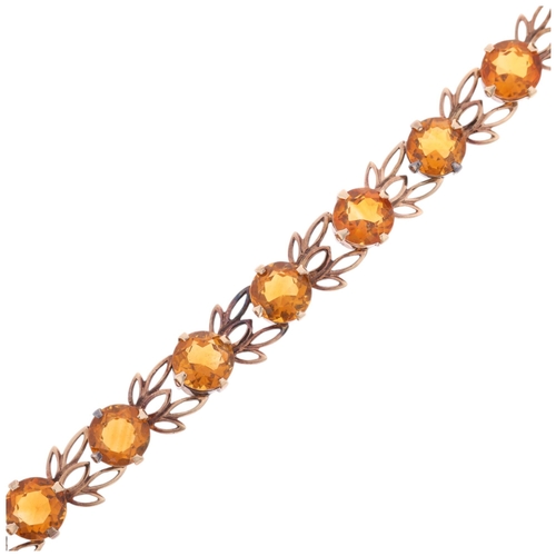 1344 - A Vintage 9ct rose gold citrine line bracelet, maker W&H, Birmingham 1959, pierced floral openwork d... 