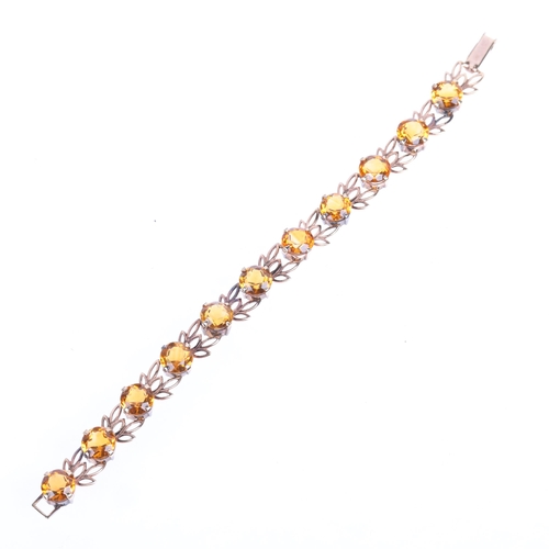 1344 - A Vintage 9ct rose gold citrine line bracelet, maker W&H, Birmingham 1959, pierced floral openwork d... 