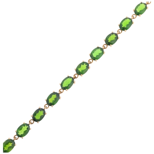 1350 - A 9ct gold peridot tennis line bracelet, set with oval mixed-cut peridots, 17.5cm, 6.3g