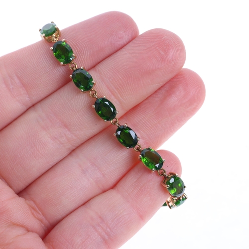 1350 - A 9ct gold peridot tennis line bracelet, set with oval mixed-cut peridots, 17.5cm, 6.3g