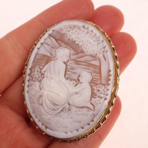 1363 - A Vintage 9ct gold shell cameo brooch, relief carved depicting Classical lady and child beside a lak... 