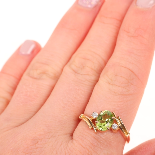 1369 - An 18ct gold three stone peridot and diamond crossover ring, set with oval mixed-cut peridot and mod... 