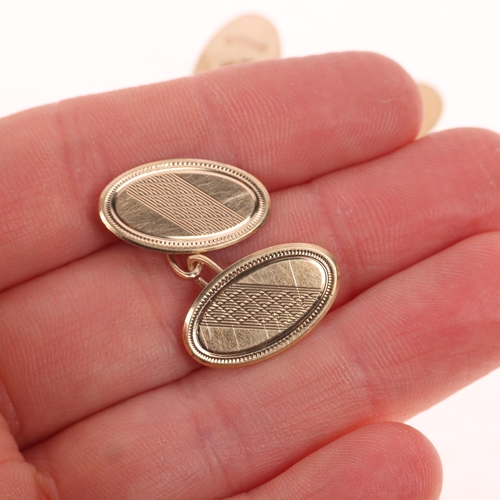 1372 - A pair of Art Deco 9ct gold oval cufflinks, maker HG&S, Chester 1932, engine turned decoration, 18.6... 