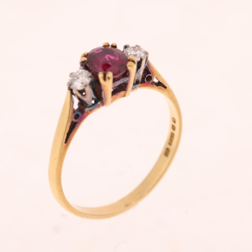 1402 - An 18ct gold three stone ruby and diamond ring, maker AJW, London 1980, set with 0.65ct oval mixed-c... 