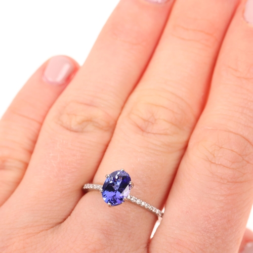 1414 - An 18ct white gold single stone tanzanite ring, maker R&G, claw set with oval mixed-cut tanzanite an... 