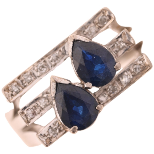 1439 - A 14ct white gold sapphire and diamond cocktail ring, in the Art Deco style, set with pear-cut sapph... 