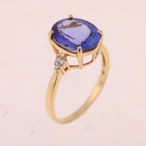 1453 - An 18ct gold tanzanite and diamond dress ring, set with oval mixed-cut tanzanite and modern round br... 