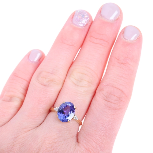 1453 - An 18ct gold tanzanite and diamond dress ring, set with oval mixed-cut tanzanite and modern round br... 