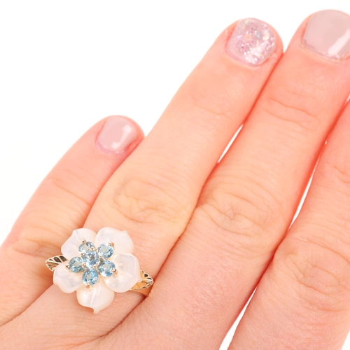 1459 - A 9ct gold blue topaz and mother-of-pearl flowerhead ring, maker QVC, Birmingham 2006, setting heigh... 