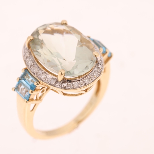 1469 - A 9ct gold aquamarine blue topaz and diamond oval cluster ring, by QVC, Birmingham 2007, claw set wi... 