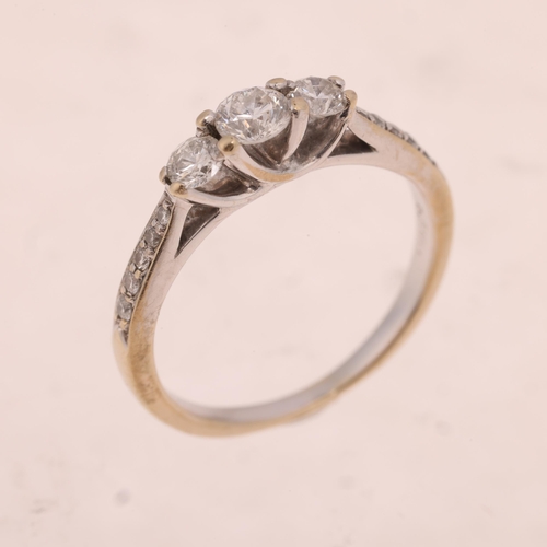 1486 - An 18ct white gold three stone diamond ring, set with modern round brilliant-cut diamonds and diamon... 