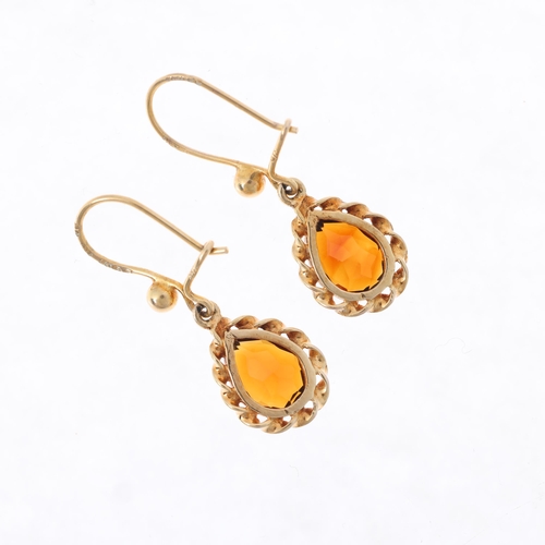 1502 - A pair of 9ct gold citrine drop earrings, rub-over set with pear-cut citrines within rope twist surr... 