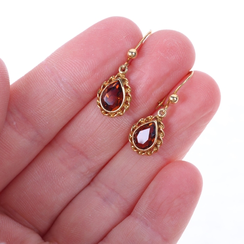 1502 - A pair of 9ct gold citrine drop earrings, rub-over set with pear-cut citrines within rope twist surr... 