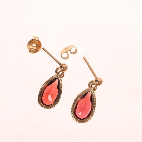 1514 - A pair of 9ct gold garnet drop stud earrings, rub-over set with pear-cut garnets, 16.8mm, 1.5g