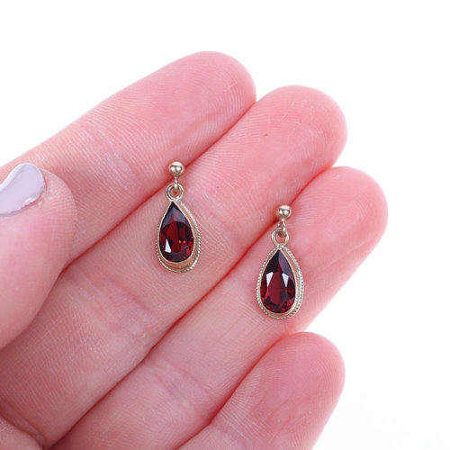 1514 - A pair of 9ct gold garnet drop stud earrings, rub-over set with pear-cut garnets, 16.8mm, 1.5g