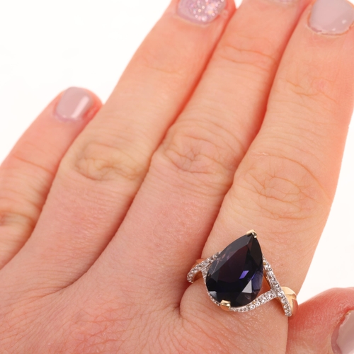 1521 - A 9ct gold tanzanite and cubic zirconia dress ring, maker R&C, set with pear-cut tanzanite and round... 