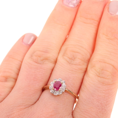 1537 - A 9ct gold ruby and diamond oval cluster ring, set with oval mixed-cut ruby and single-cut diamonds,... 