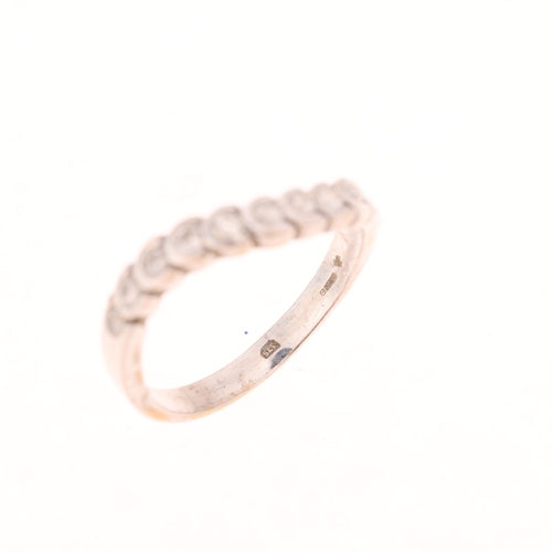 1538 - A 9ct white gold diamond wavy half eternity ring, set with modern round brilliant-cut diamonds, tota... 