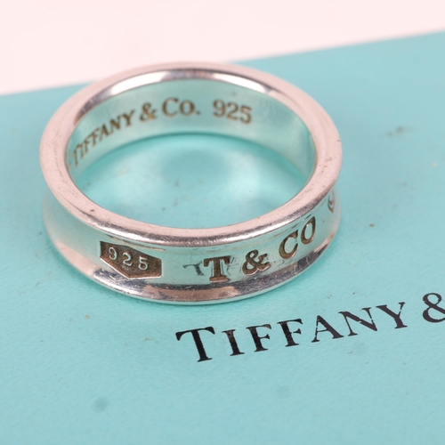 1582 - TIFFANY & CO - a sterling silver band ring, circa 1997, band width 7mm, size T, 8.6g