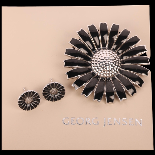 1610 - GEORG JENSEN - a Danish modernist sterling silver black enamel daisy pattern matching brooch and stu... 