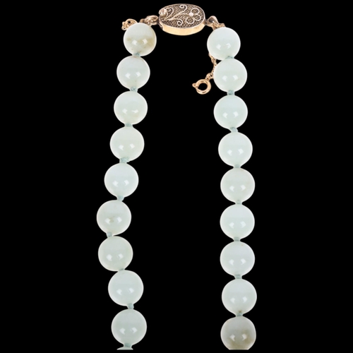 1699 - A Chinese single-strand jade bead necklace, with silver-gilt and floral clasp, 10.1mm beads, 50cm, 8... 