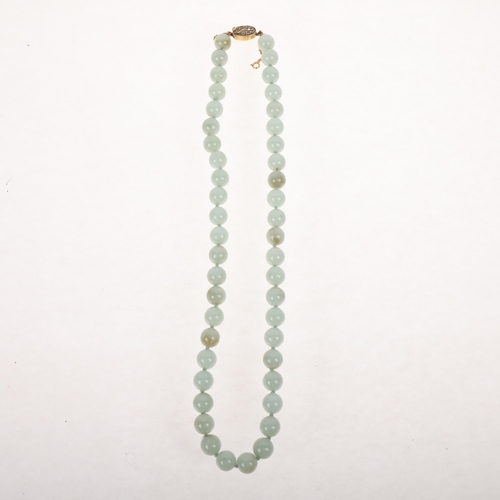 1699 - A Chinese single-strand jade bead necklace, with silver-gilt and floral clasp, 10.1mm beads, 50cm, 8... 