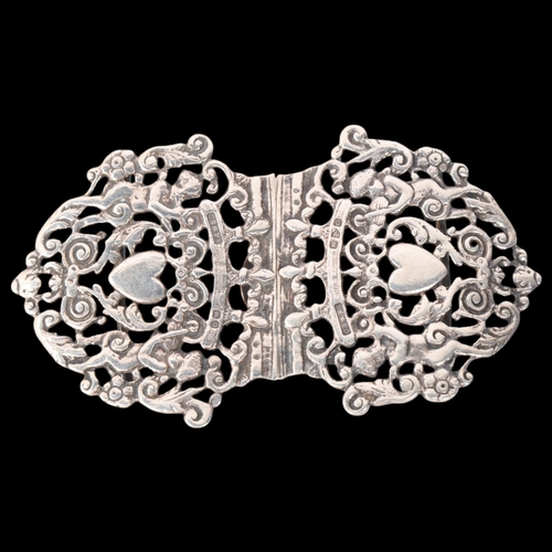 1764 - A late Victorian silver nurse's buckle, Saunders & Shepherd, Chester 1897, pierced heart and cherub ... 