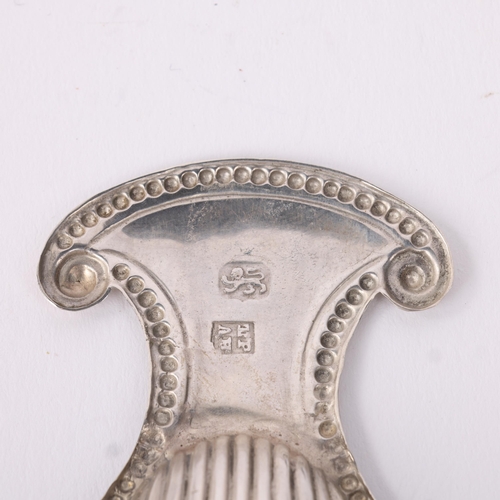 1772 - A George III silver shell tea caddy spoon, Thomas Pratt & Arthur Humphreys, no date letter, with rel... 