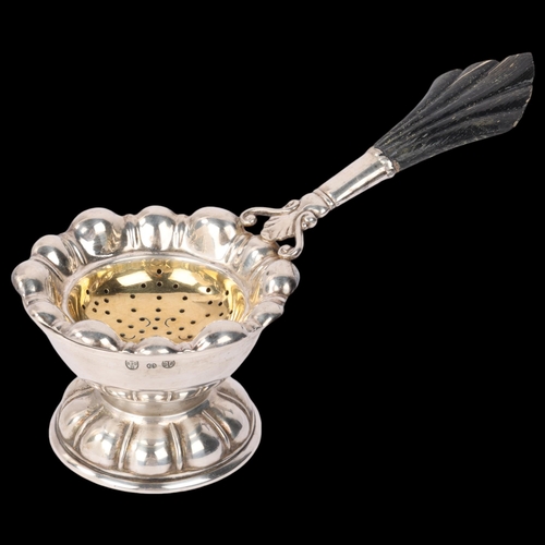 1807 - CARL M COHR - an Art Nouveau Danish silver tea strainer on stand, stylised form with ebonised handle... 