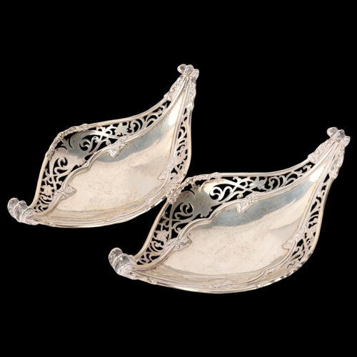 1819 - A pair of George V silver bon bon baskets, Mappin & Webb, London 1930, boat form with relief embosse... 