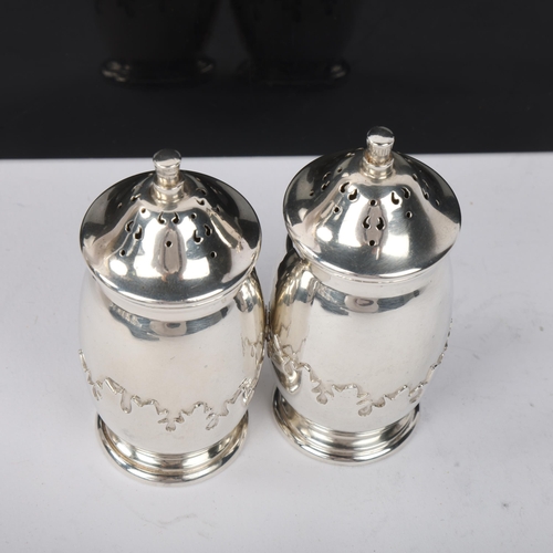 1837 - A pair of George V silver pepperettes, Roberts & Dore Ltd, Birmingham 1935, ovoid form with relief e... 