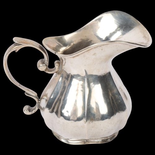 1894 - A Continental 800 silver cream jug, pumpkin form with scrolled handle, marks on base, 10cm, 5.5oz