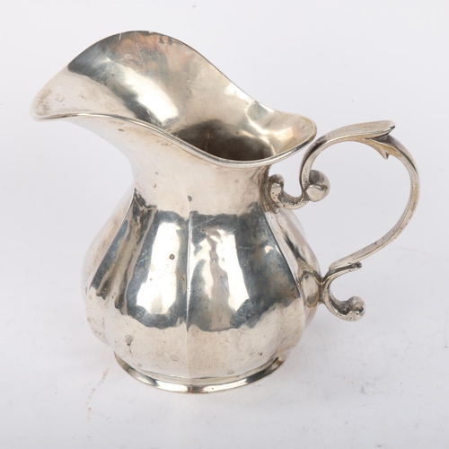 1894 - A Continental 800 silver cream jug, pumpkin form with scrolled handle, marks on base, 10cm, 5.5oz