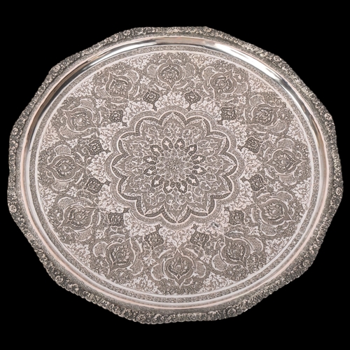 1907 - An Antique Persian silver tray, allover chased and engraved foliate decoration, with cast rim, unmar... 