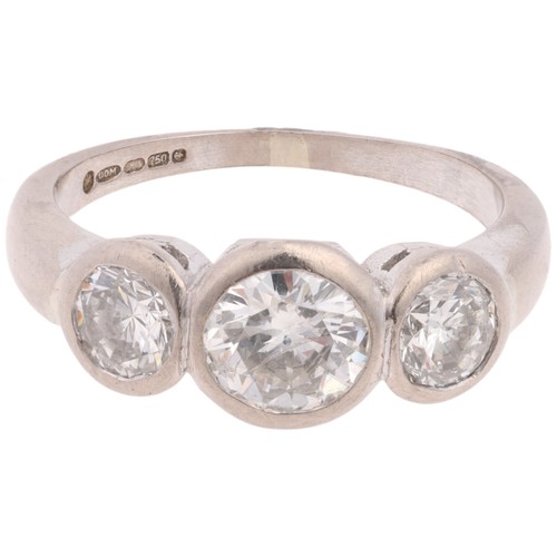 1208 - An 18ct white gold three stone diamond ring, rub-over set with modern round brilliant-cut diamonds, ... 