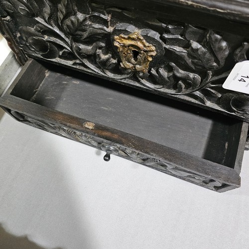 14 - An early 19th century Sri Lankan ebony box, circa 1830, relief carved allover with hinged lid and dr... 