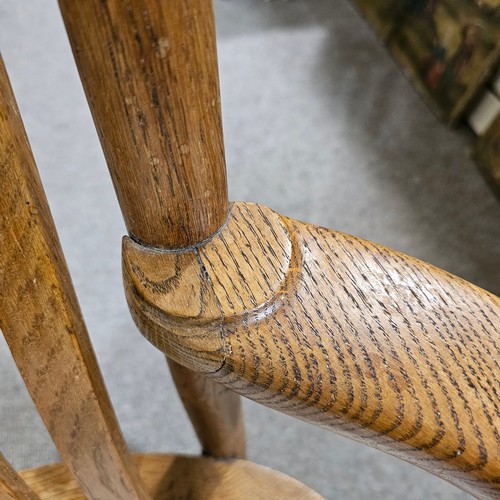 151 - An oak Arts & Crafts chair by James Shoolbred, Tottenham Court Road, London, with 6 legs and scrolle... 