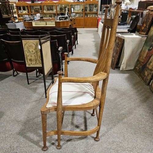 151 - An oak Arts & Crafts chair by James Shoolbred, Tottenham Court Road, London, with 6 legs and scrolle... 