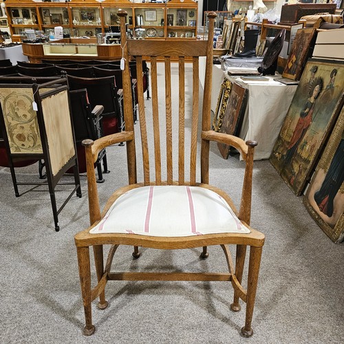 151 - An oak Arts & Crafts chair by James Shoolbred, Tottenham Court Road, London, with 6 legs and scrolle... 