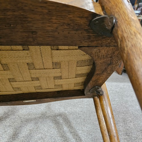 151 - An oak Arts & Crafts chair by James Shoolbred, Tottenham Court Road, London, with 6 legs and scrolle... 