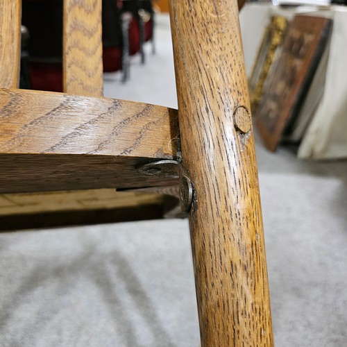 151 - An oak Arts & Crafts chair by James Shoolbred, Tottenham Court Road, London, with 6 legs and scrolle... 