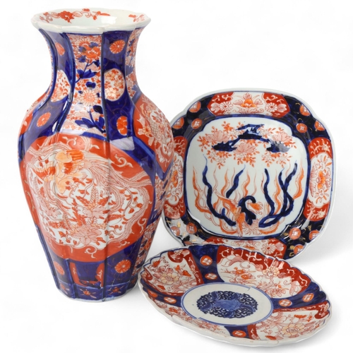 196 - A Chinese blue and red decorated Imari porcelain vase, height 30cm, and 2 similar Imari plates (1 br... 