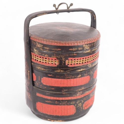 24 - A Chinese black and red lacquered 3-section wedding basket, gilded decoration, H46cm