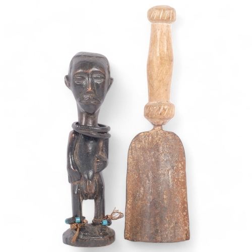 26 - A Tribal hand bell, metal with carved wood handle, L29cm, together with a Bakongo Tribal carved wood... 