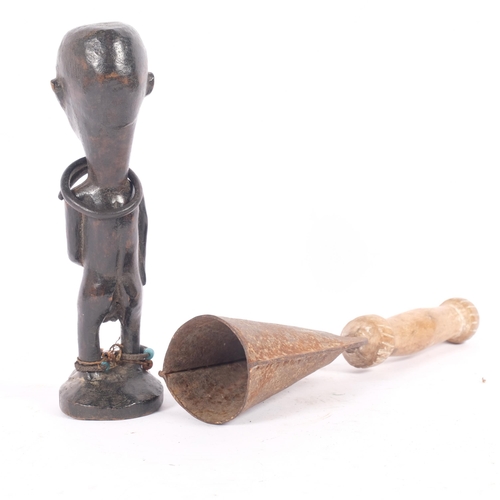 26 - A Tribal hand bell, metal with carved wood handle, L29cm, together with a Bakongo Tribal carved wood... 