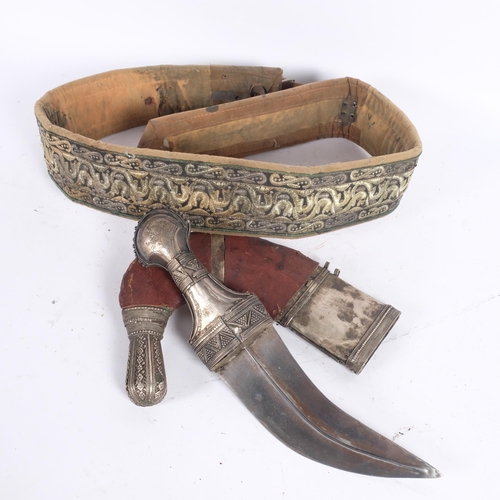 42 - An Antique Jambiya dagger with sheath, length approx 40cm, and ceremonial fabric belt (2)