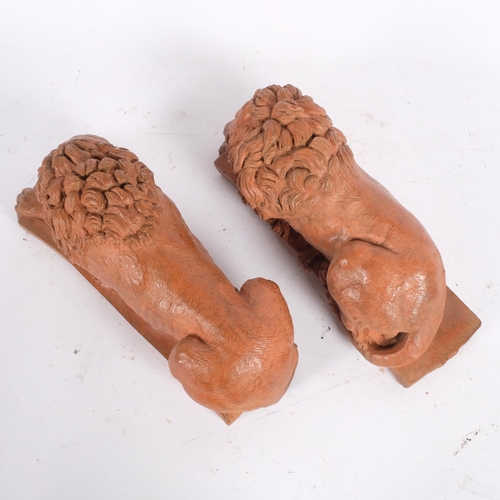 64 - A pair of terracotta recumbent lions, L30cm