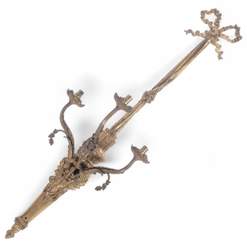 66 - A large gilt-brass 3-branch wall sconce, with ribbon and bow pediment, L104cm